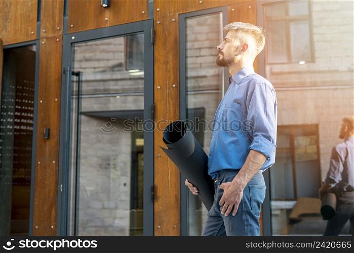 side view architect holding blueprints