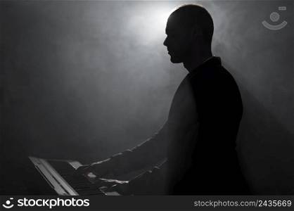 side view artist playing piano smoke shadows effects