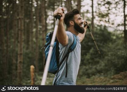 Side view at young bearded hiker in mountain