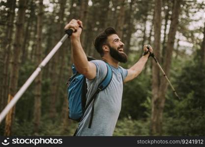 Side view at young bearded hiker in mountain