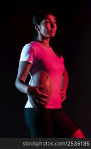 side view athletic female rugby player holding ball