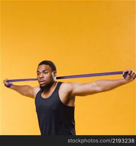 side view athletic man pulling resistance band
