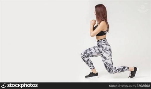 side view athletic woman doing lunges