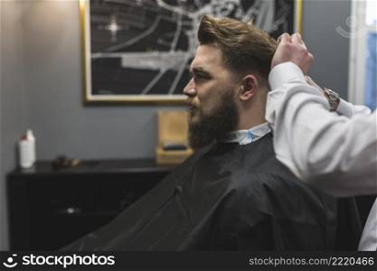 side view barber cutting hair client