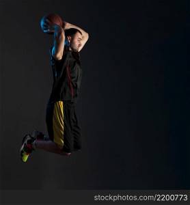 side view basketball player dunking with copy space
