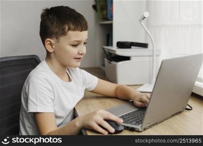 side view boy home using laptop