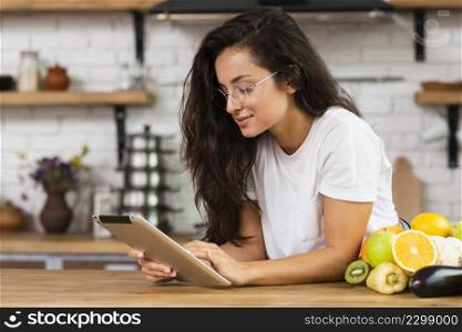 side view brunette woman with tablet