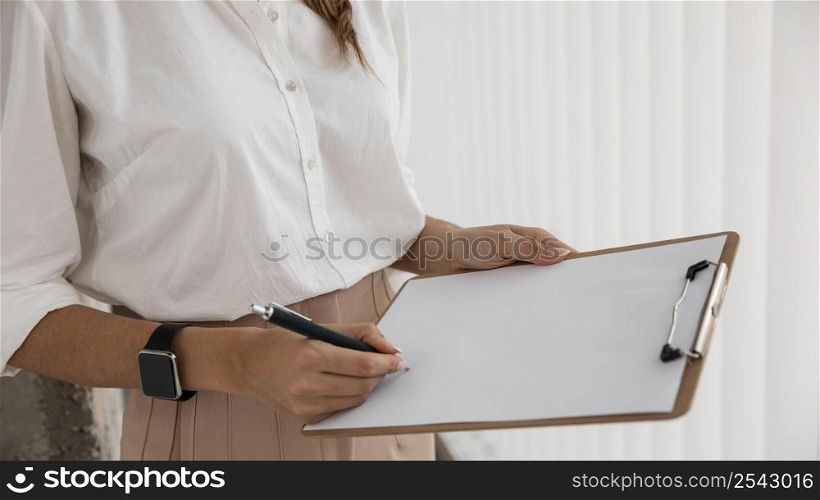 side view businesswoman with clipboard
