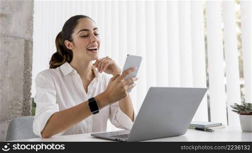 side view businesswoman with smartphone laptop