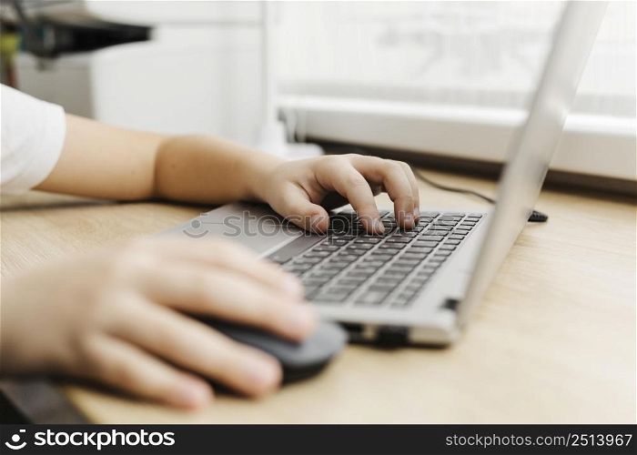 side view child using laptop