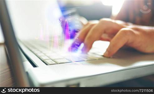 Side view Close up of man hands typing on laptop in office with hologram and icons. Concept of Business and finance hi tech in business.