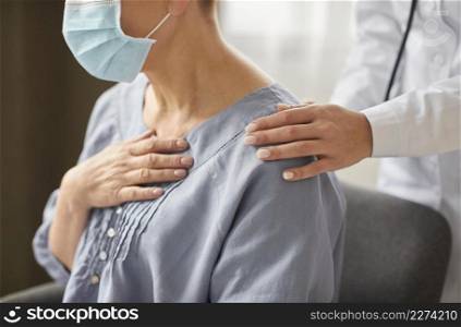 side view covid recovery center female doctor checking elder patient. Resolution and high quality beautiful photo. side view covid recovery center female doctor checking elder patient. High quality beautiful photo concept