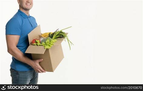 side view delivery man posing with grocery box