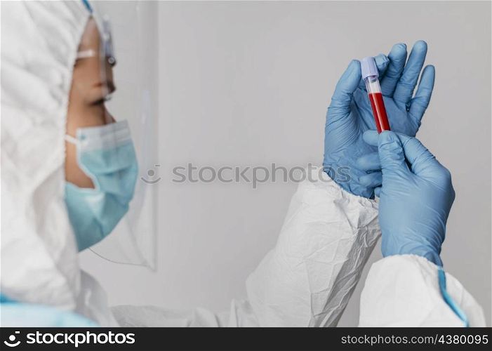 side view doctor holding blood sample