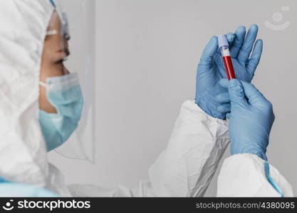 side view doctor holding blood sample