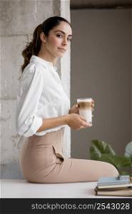 side view elegant businesswoman posing with coffee