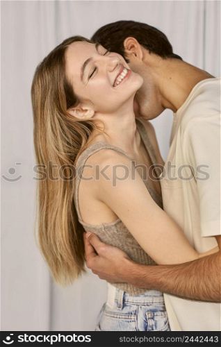 side view embraced smiley couple