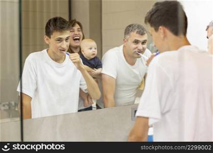 side view family looking mirror