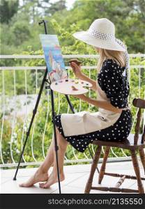 side view female artist painting outdoors