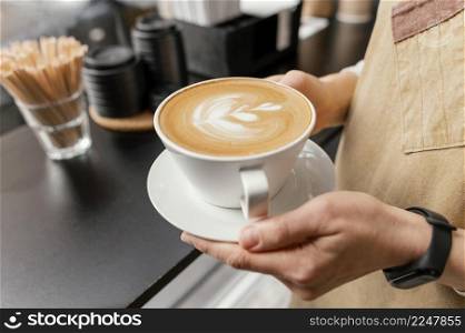 side view female barista holding decorated cup coffee hands