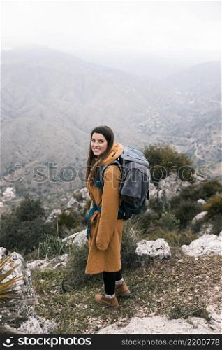 side view female hiker with her backpack hiking mountains