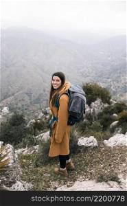 side view female hiker with her backpack hiking mountains