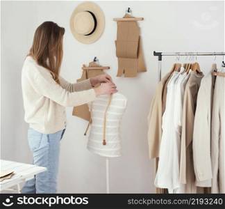 side view female tailor studio with clothes