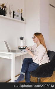 side view female teacher desk during online class