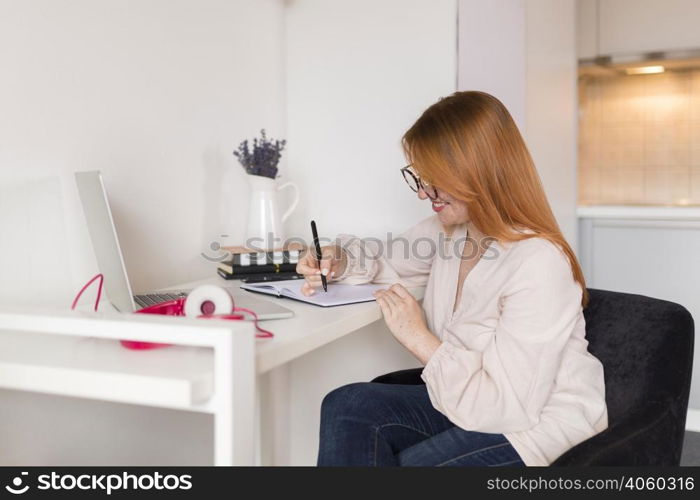 side view female teacher during online class desk