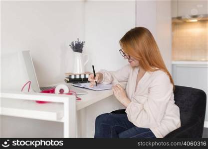 side view female teacher during online class desk