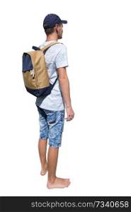 Side view full length portrait of a casual young man traveler carrying a backpack and wearing a cap ready for adventure isolated over white background.