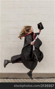 side view girl jumping graduation