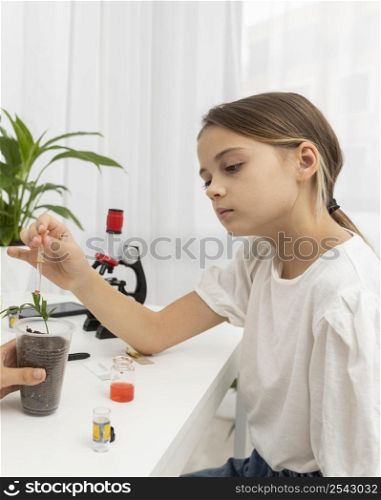 side view girl learning about science with plant