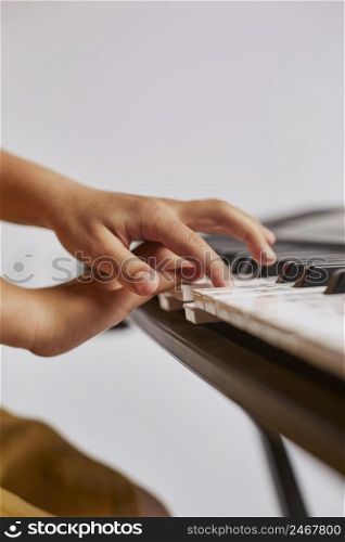 side view girl learning how play electronic keyboard
