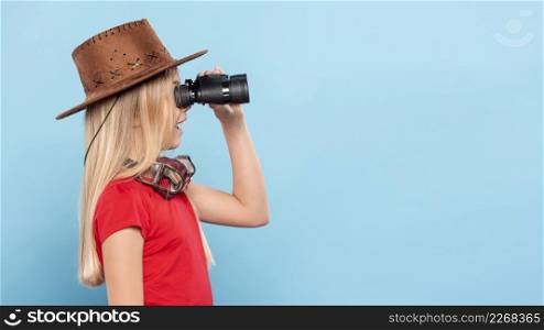 side view girl looking with binocular