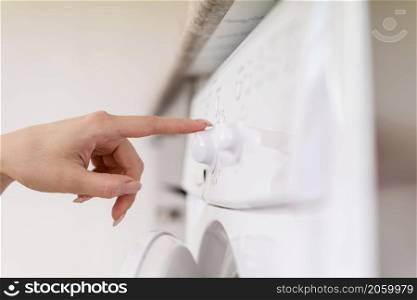 side view hand touching washing machine