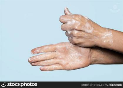 side view hands washing with soap