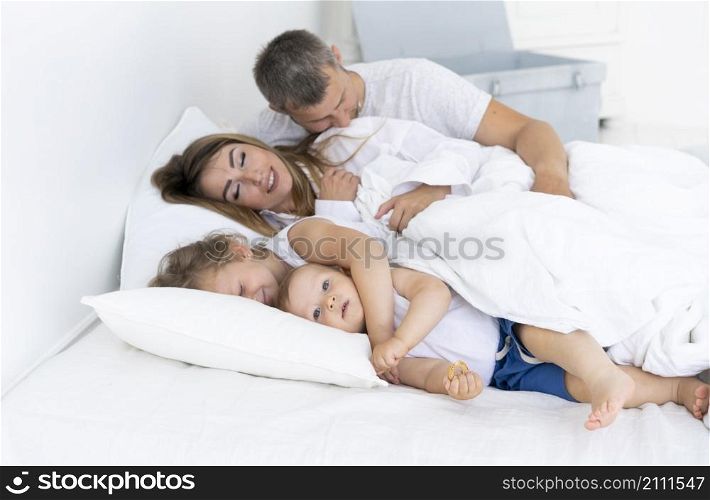 side view happy family laying bed