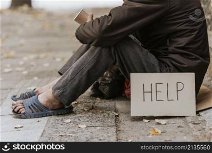 side view homeless man street with cup help sign