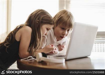 side view kids using laptop together
