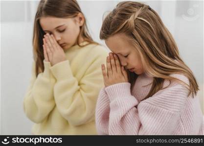 side view little girls praying home
