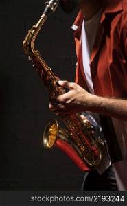 side view male musician playing saxophone