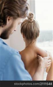 side view male osteopathic therapist checking female patient s spine