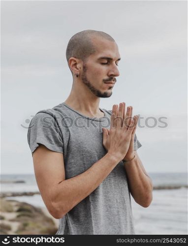 side view man doing yoga outdoors