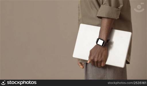 side view man holding laptop