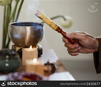 side view man holding object prayer with candles bowl