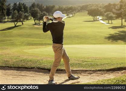 side view man playing golf with club