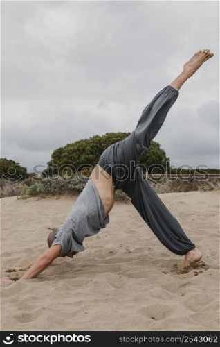 side view man practicing yoga outdoors