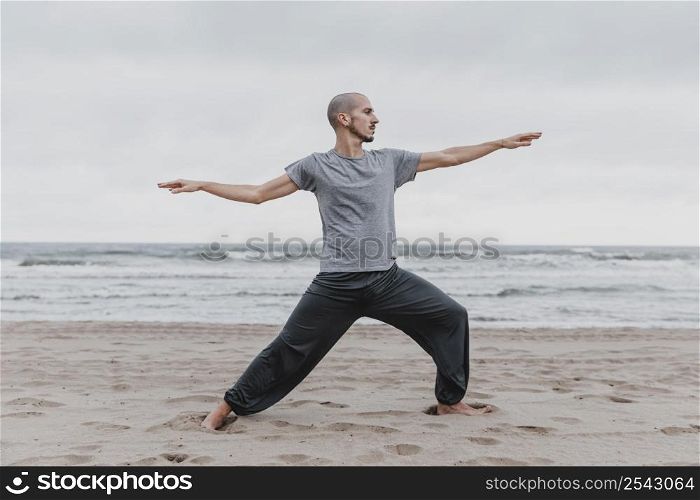side view man practicing yoga positions outdoors