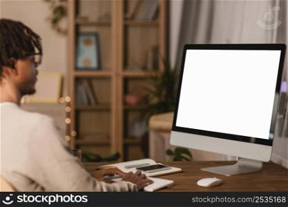 side view man using computer home